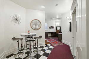 Dining room featuring built in study area and dark floors