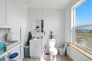 Bathroom with light tile patterned floors and vanity