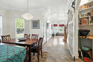 Dining room featuring a chandelier and crown molding