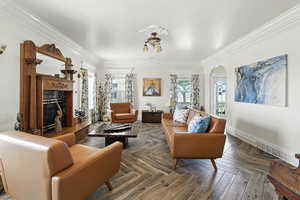 Living area featuring a high end fireplace and ornamental molding
