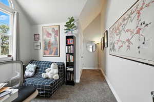 Sitting room with lofted ceiling and carpet floors