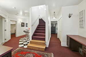 Stairs featuring carpet flooring and baseboards
