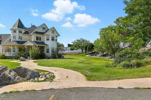 View of front of property featuring a porch and a front lawn