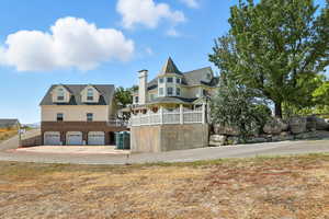 View of front of property featuring concrete driveway and a garage