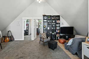 Sitting room with vaulted ceiling and carpet floors
