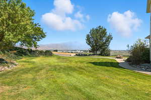 View of green lawn featuring a mountain view