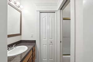 Full bath featuring vanity, a closet, and shower / bath combination with glass door