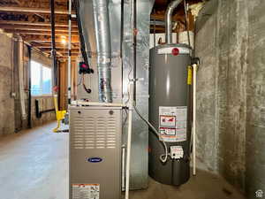 Utility room featuring water heater and heating unit