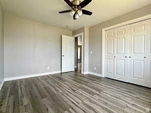 Unfurnished bedroom featuring light wood-style flooring, ceiling fan, and a closet