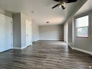 Unfurnished bedroom featuring wood finished floors, ceiling fan, and access to exterior