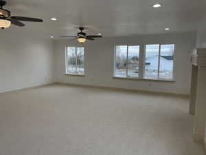 Unfurnished room with light colored carpet and recessed lighting