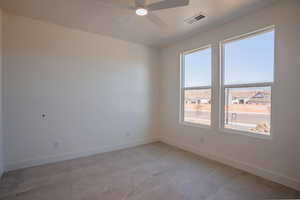Empty room with baseboards and a ceiling fan