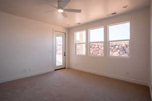 Unfurnished room with light colored carpet and ceiling fan