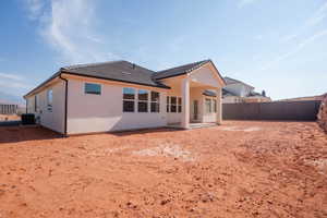 Back of house featuring a patio area, a fenced backyard, a tiled roof, and stucco siding