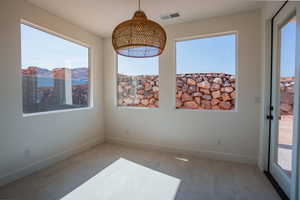 Unfurnished dining area with baseboards and a mountain view
