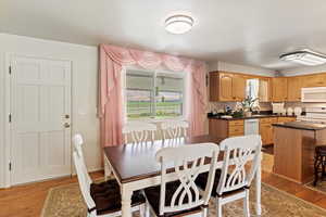 Dining space with light wood finished floors and baseboards