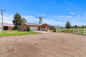 Single story home featuring a mountain view, a metal roof, driveway, an attached garage, and a porch