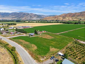 Aerial view of sparsely populated area with a mountain backdrop and farmland