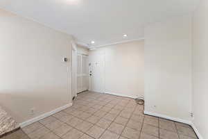 Empty room with recessed lighting and light tile patterned floors