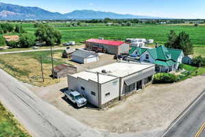Overview of rural landscape featuring a mountainous background and large plots for crops