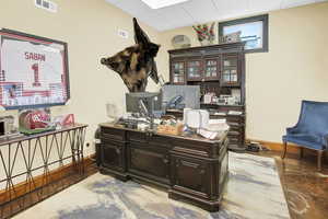 Home office with a paneled ceiling and baseboards