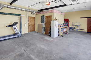 Garage with a garage door opener and a workshop area