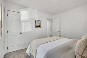 Bedroom featuring carpet flooring and a closet