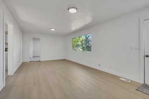Unfurnished room featuring light wood-style flooring and baseboards