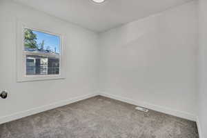 Empty room with baseboards and carpet floors