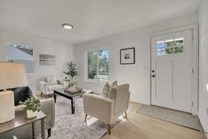 Living area featuring light wood finished floors and baseboards