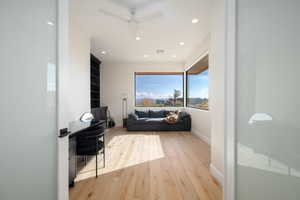 Cinema with light wood-style floors, recessed lighting, and ceiling fan