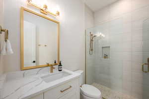 Bathroom featuring vanity and a stall shower