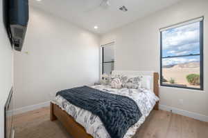 Bedroom with light wood-type flooring, recessed lighting, and ceiling fan