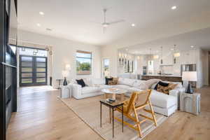 Living area featuring recessed lighting, light wood-type flooring, a ceiling fan, and french doors