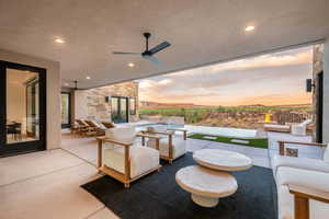 View of patio featuring outdoor lounge area, a ceiling fan, and an in-ground hot tub