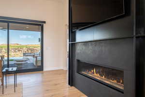 Detailed view of a fireplace and wood finished floors