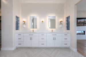 Full bathroom with double vanity and parquet floors