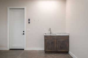 Washroom with baseboards and a sink
