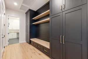 Mudroom featuring light wood-style flooring and baseboards