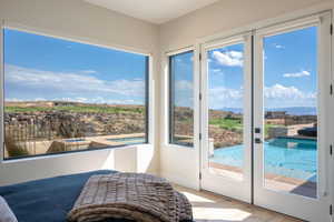 Doorway featuring wood finished floors and baseboards