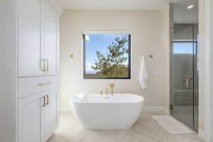 Full bath featuring a stall shower and a freestanding bath