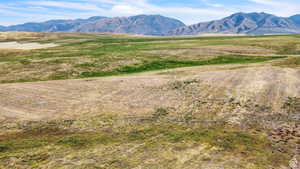 View of mountain backdrop with rural landscape