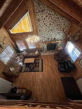 Living room featuring high vaulted ceiling and wood finished floors