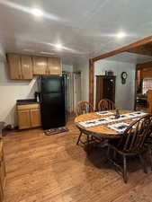 Dining room with light wood-style flooring and a textured ceiling