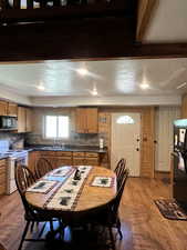 Dining space with light wood-style flooring and a textured ceiling