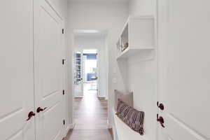 Mudroom with baseboards and light wood finished floors