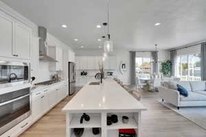 Kitchen with open shelves, open floor plan, stainless steel appliances, plenty of natural light, and recessed lighting