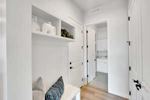 Mudroom featuring light wood finished floors