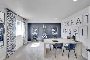 Dining area with light carpet, an office area, a textured ceiling, and recessed lighting