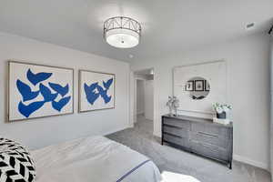 Bedroom with light carpet and baseboards